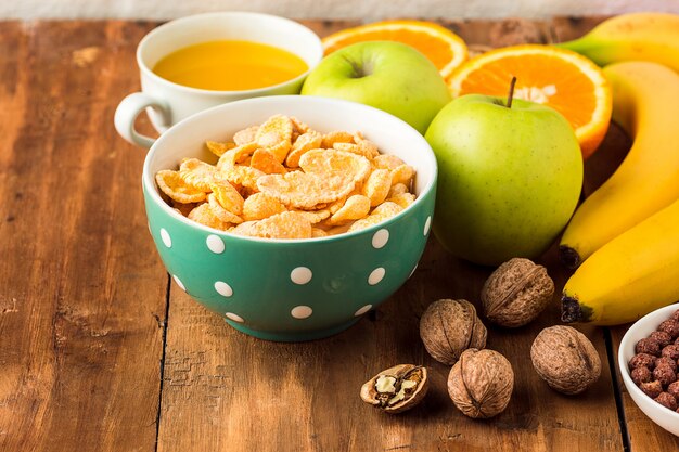 Healthy home made breakfast of muesli, apples, fresh fruits and walnuts