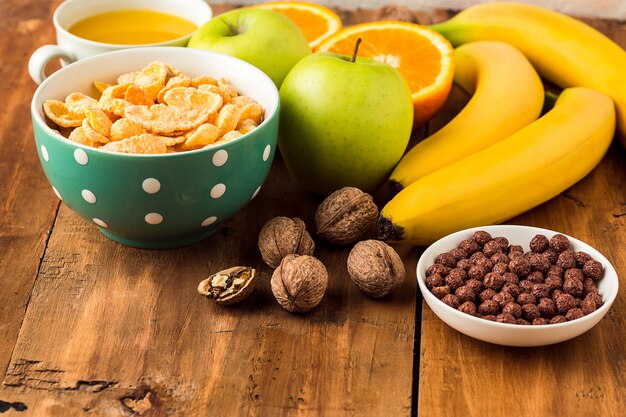 Healthy home made breakfast of muesli, apples, fresh fruits and walnuts