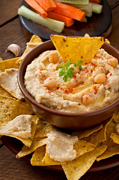 healthy homemade  hummus with olive oil and pita chips