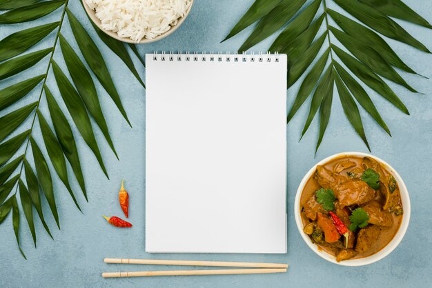 Healthy homemade stew dish and empty notepad