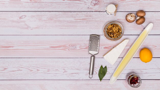 Healthy ingredient with stainless grater over wooden table