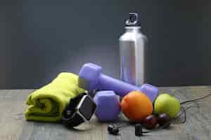 Free photo healthy lifestyle dumbbell smart watch and fruit