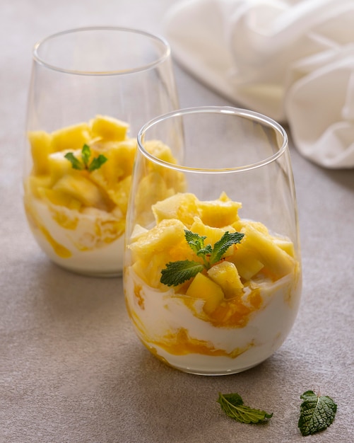 Free photo healthy meal with yogurt and pineapple in glass