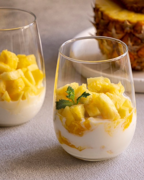 Free photo healthy meal with yogurt and pineapple in glass