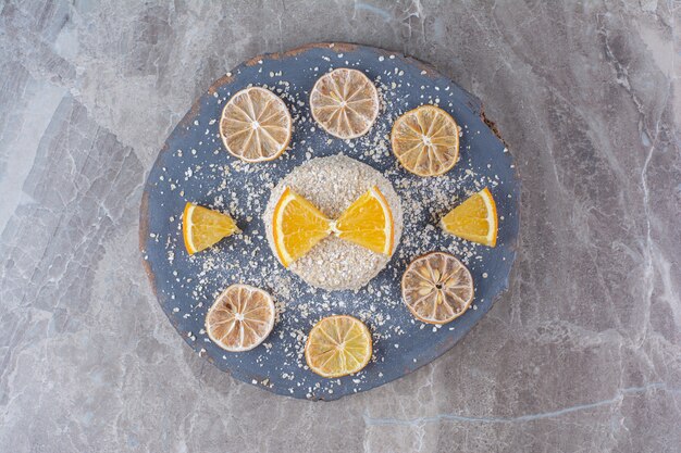 Healthy oatmeal porridge with slices of orange fruit on a wooden piece. 