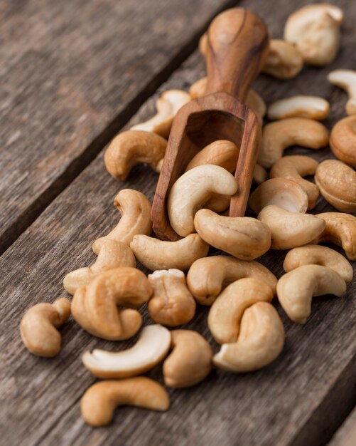 Healthy raw cashew nuts and small wooden spoon