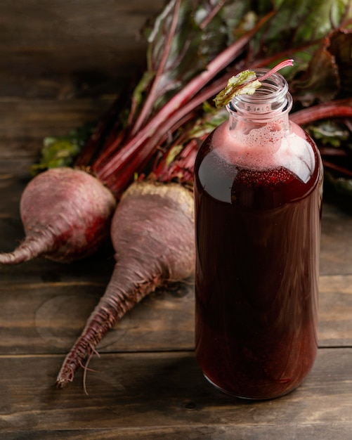 Free photo healthy red drink in glass bottle arrangement