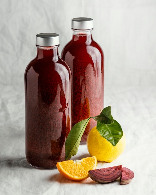 Free photo healthy red drink in glass bottle arrangement