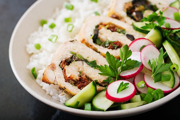 Healthy salad with chicken rolls, radishes, cucumber, green onion and rice. Proper nutrition.