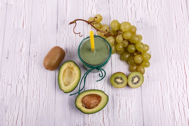 healthy smoothie with grape,avocado and kiwi lie on the table