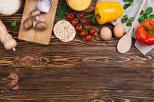 Free photo healthy vegetables; eggs; puffed rice cake and polenta on wooden desk