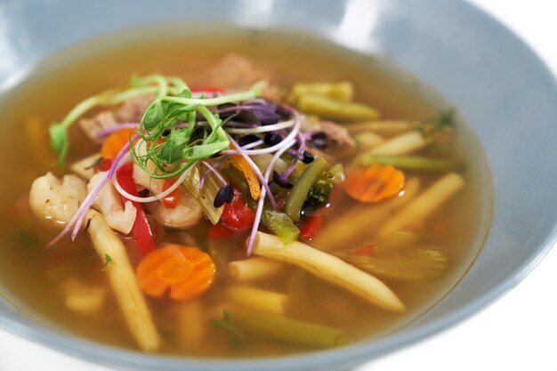 Healthy vegetables soup with different fresh greens