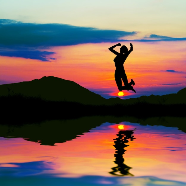 Healthy woman jumping with sun background