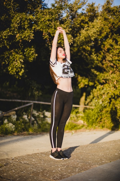 Free photo healthy woman standing and stretching