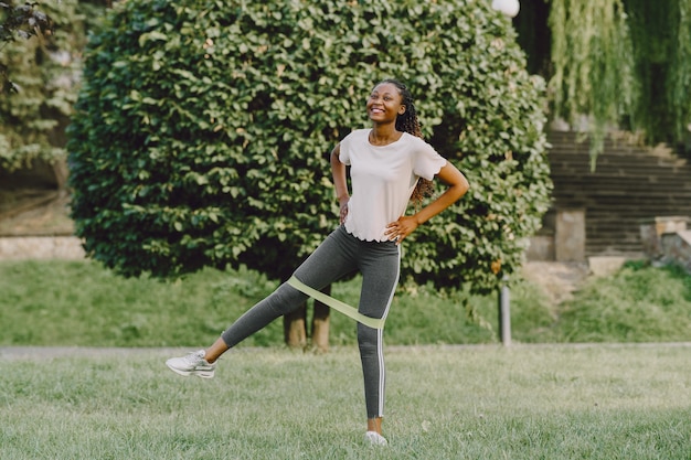 Healthy young african woman outdoors in morning. Girl with eraser.