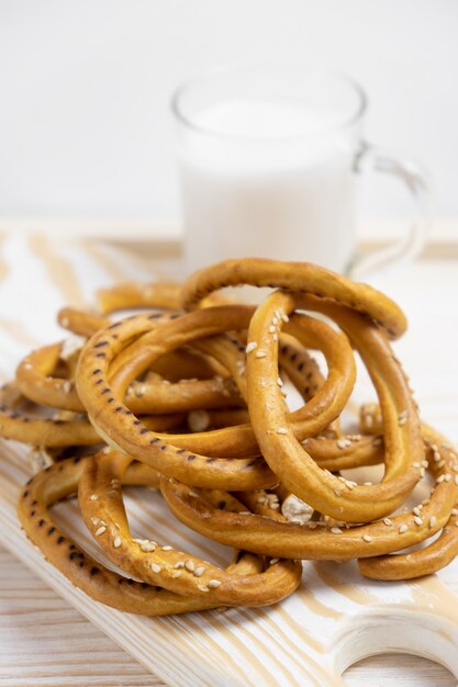 Heap of bagels with sesame seeds on wooden background