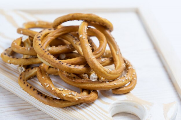 Heap of bagels with sesame seeds on wooden background