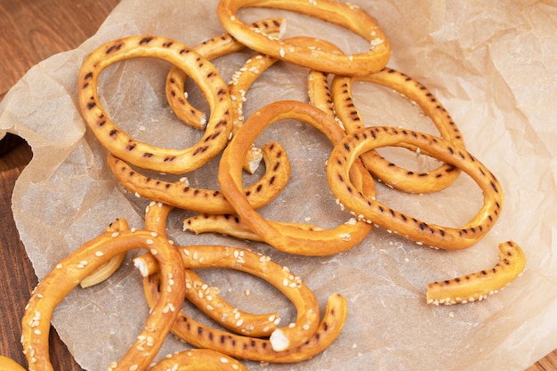 Heap of bagels with sesame seeds on wooden background