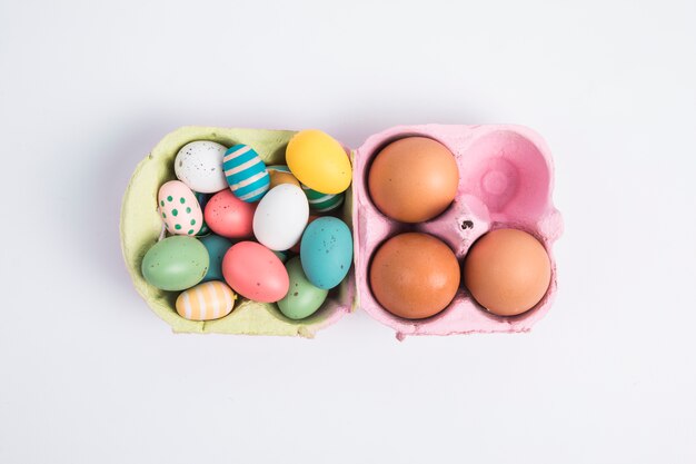 Heap of bright Easter chicken eggs in container