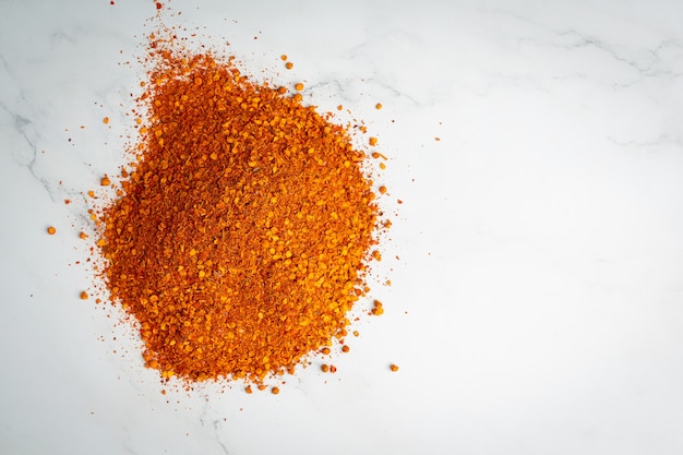 the heap of Cayenne pepper on white floor