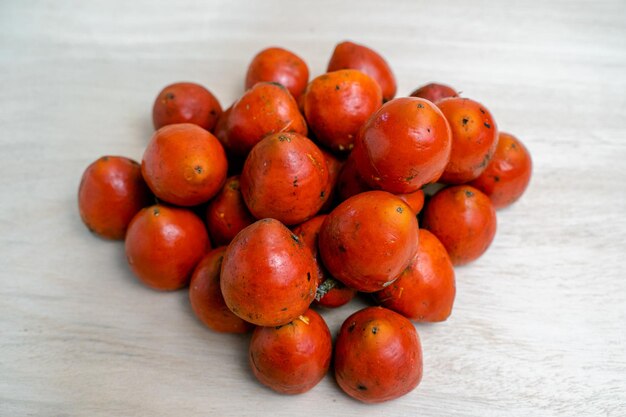 Heap of chontaduro fruits on the light surfac