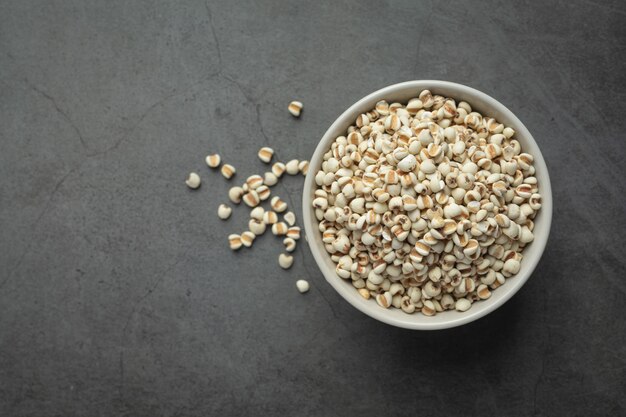 Heap of millet seeds on dark background