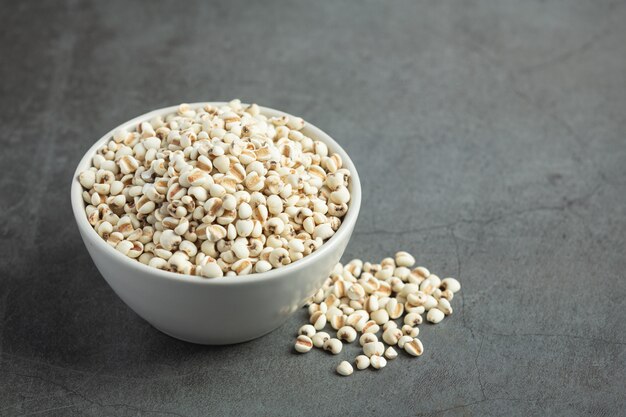 Heap of millet seeds on dark background