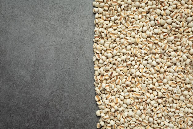 Heap of millet seeds on dark background