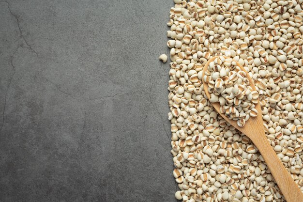 Heap of millet seeds on dark background