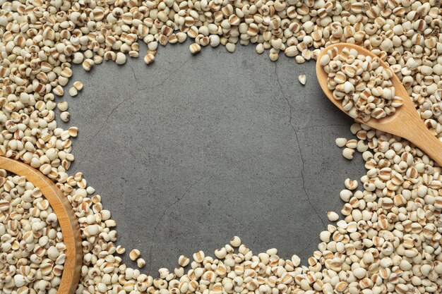 Heap of millet seeds on dark background
