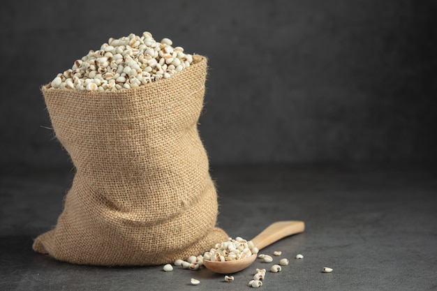 Heap of millet seeds on dark background