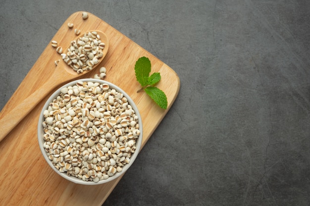 Heap of millet seeds on dark background