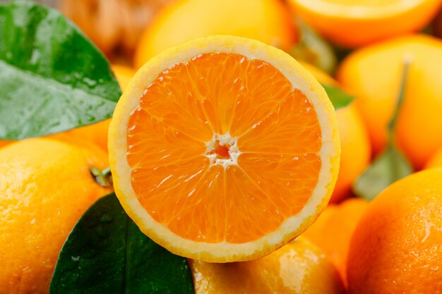 Heap of orange with green leaves close-up