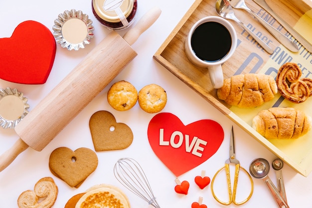 Free photo heart amidst pastry and coffee