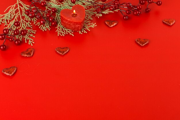 Heart candle with berries on table