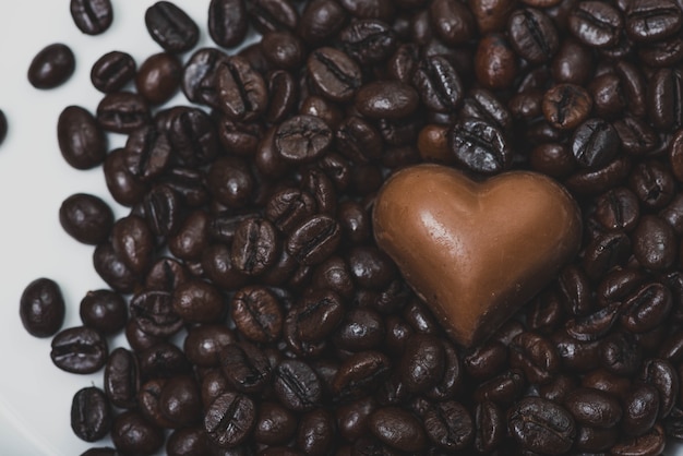 Free photo heart of chocolate on coffee beans