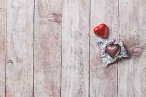 Free photo heart of chocolate on a wooden table