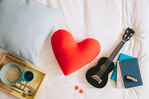 Free photo heart cushion and ukulele