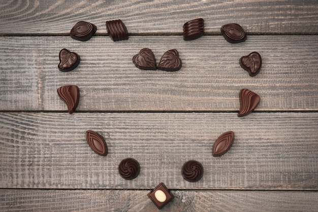 Free photo heart shape composition of chocolate candies