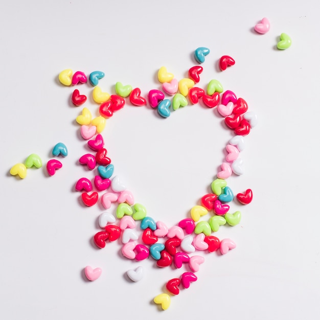 Heart shape from small candies on table 