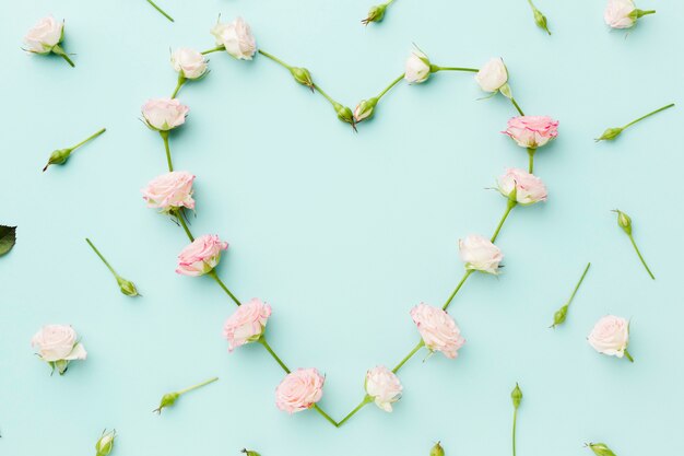 Heart shape made from flowers flat lay