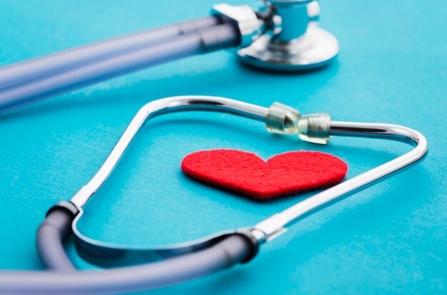 Heart shape in the stethoscope on blue background
