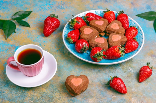 Heart shaped chocolate and strawberry cookies with fresh strawberries