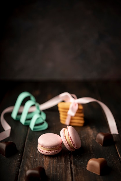 Heart-shaped chocolates with macarons and copy space