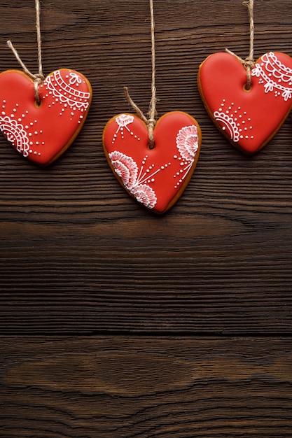 Heart-shaped cookies hanging from ropes in vertical