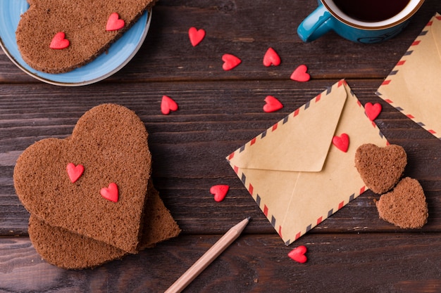 Heart-shaped cookies with sprinkles and envelope