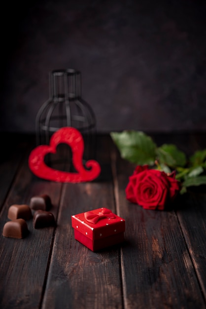 Free photo heart-shaped valentines day chocolates with present and rose