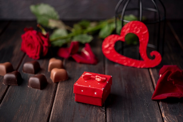Free photo heart-shaped valentines day chocolates with present