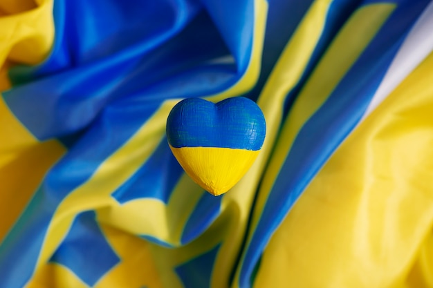 Heart with ukrainian flag on ukrainian flags