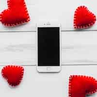 Free photo hearts around smartphone